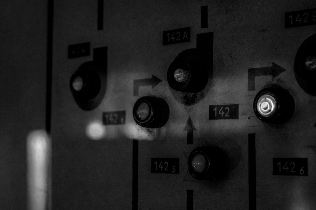 Broadcast control room mixing panel with switches and monitors