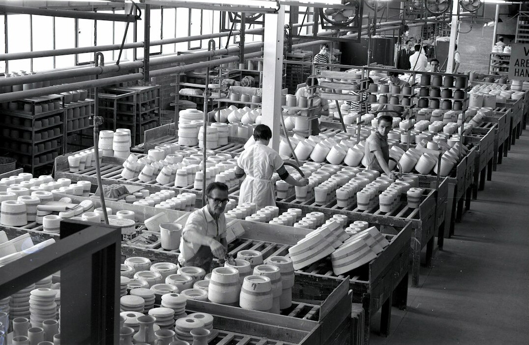Archivist examining film reels in an archive room